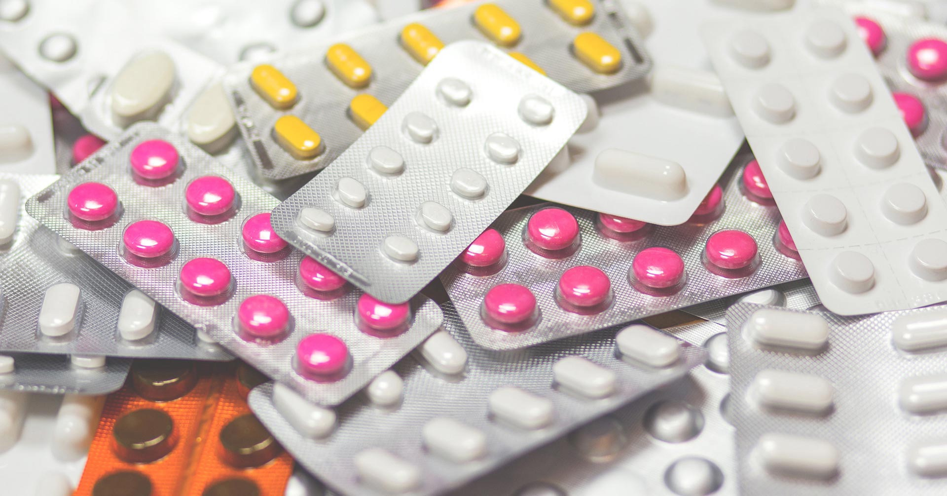 A close-up of various packages of pills and medications