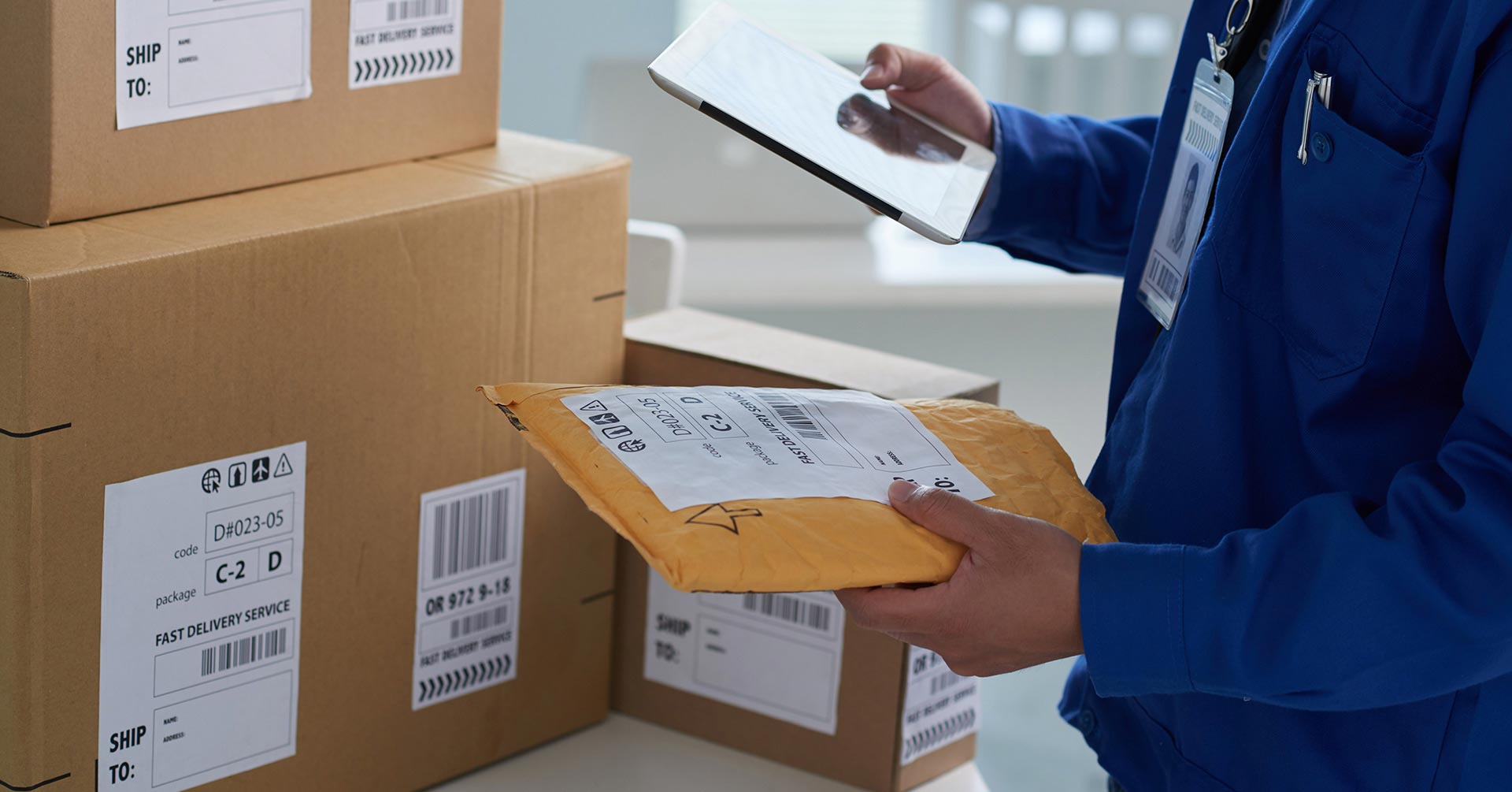 Man checkig shipping info on packages