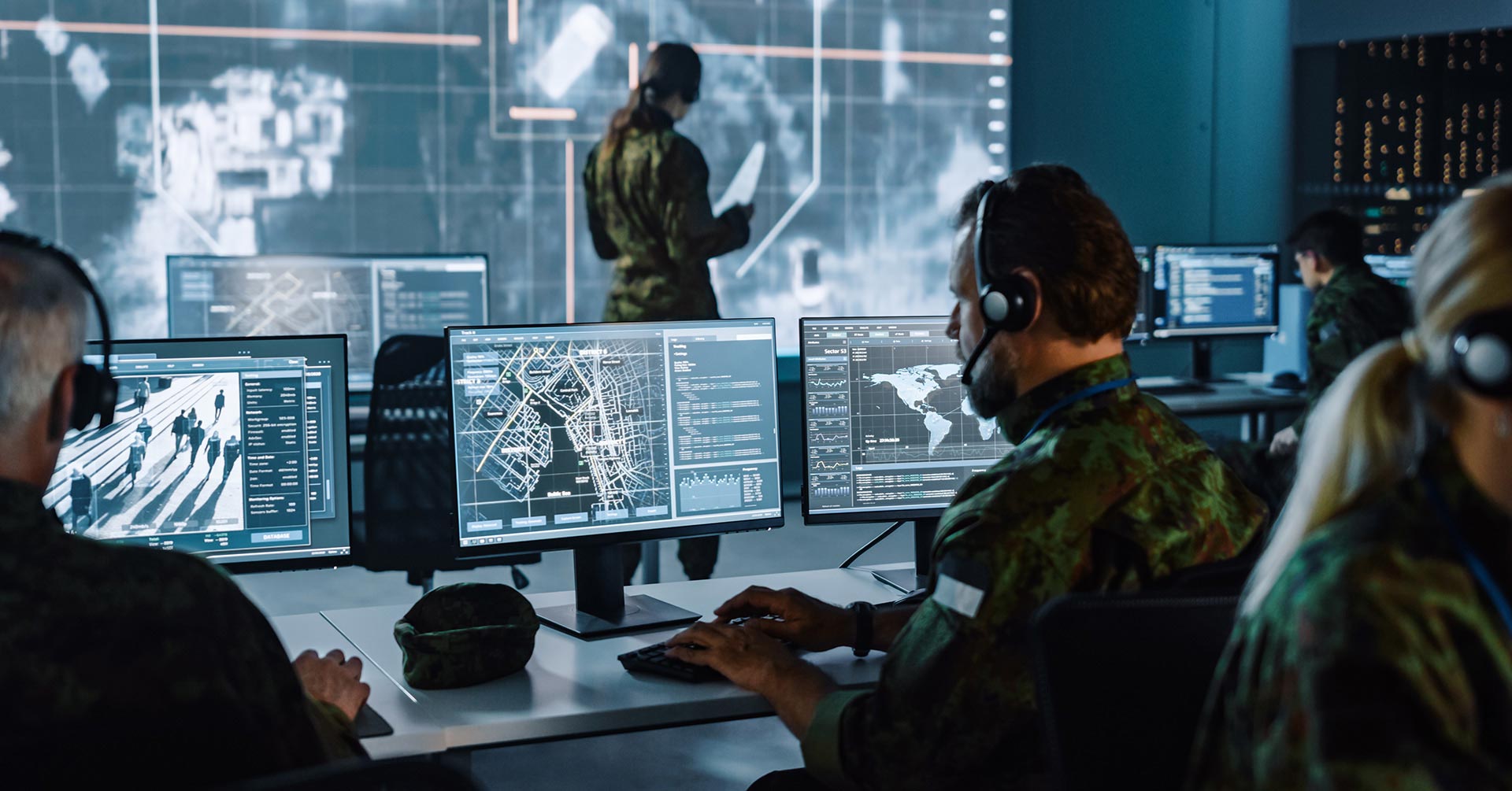 Military personnel working at computers in a global security operations center