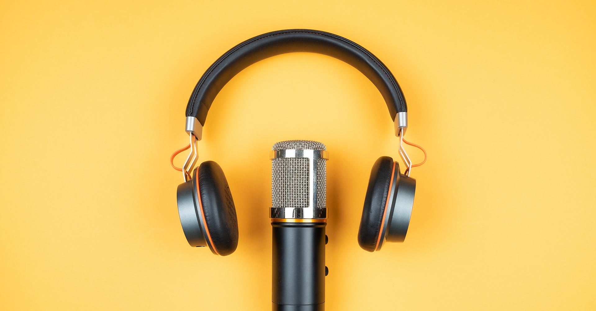 Headphones and microphone on a yellow background