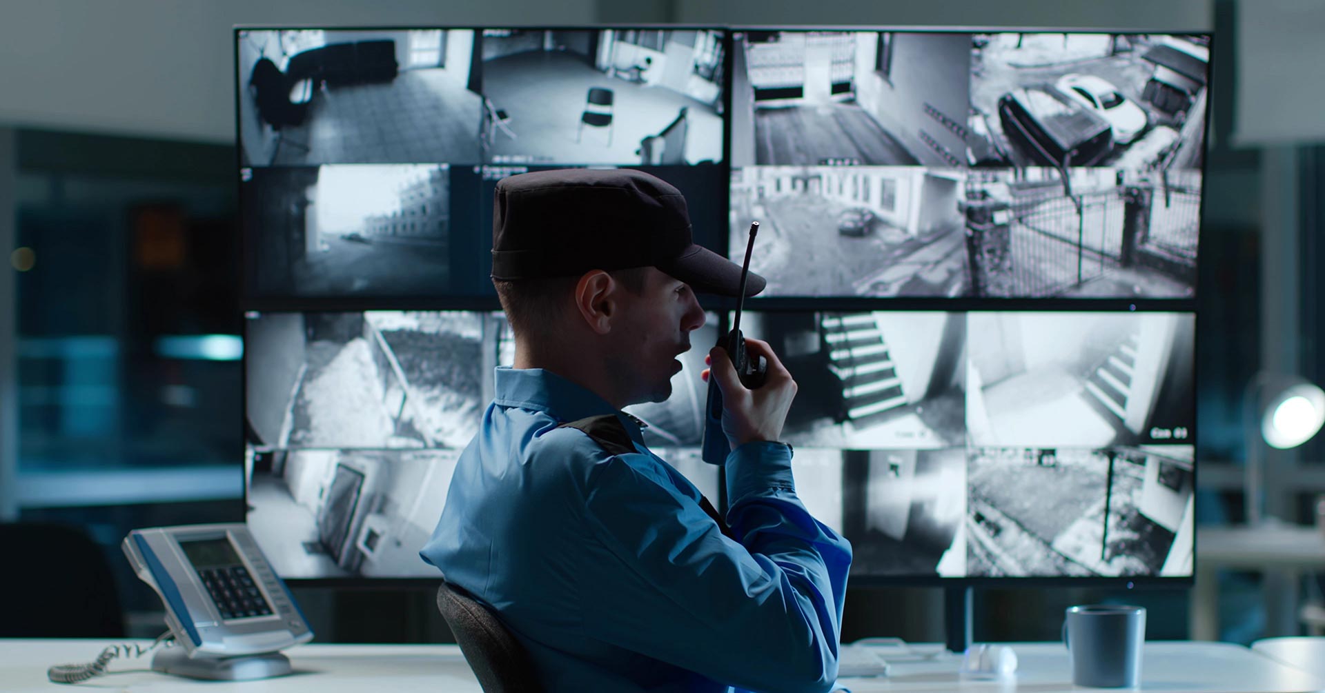 Security guard sitting in front of multiple monitors