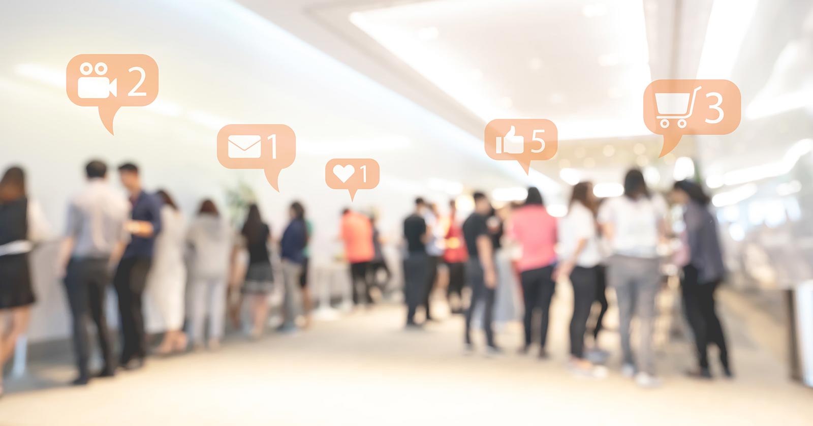 A blurred crowd of people with social media notification icons floating above their mobile devices