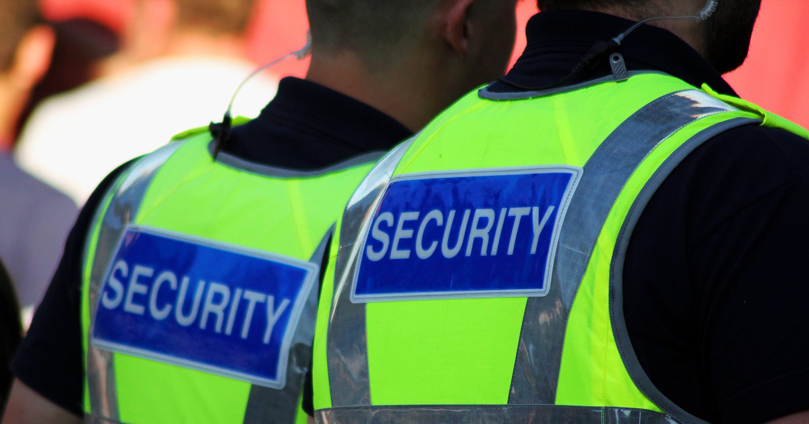 Two security guards in bright vests