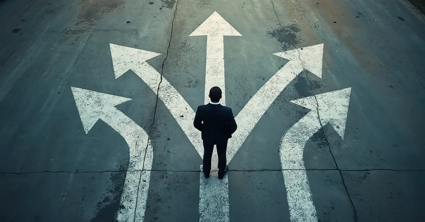 Business leader standing at a crossroads of multiple arrows, symbolizing how security teams use decision intelligence to choose the right path forward.
