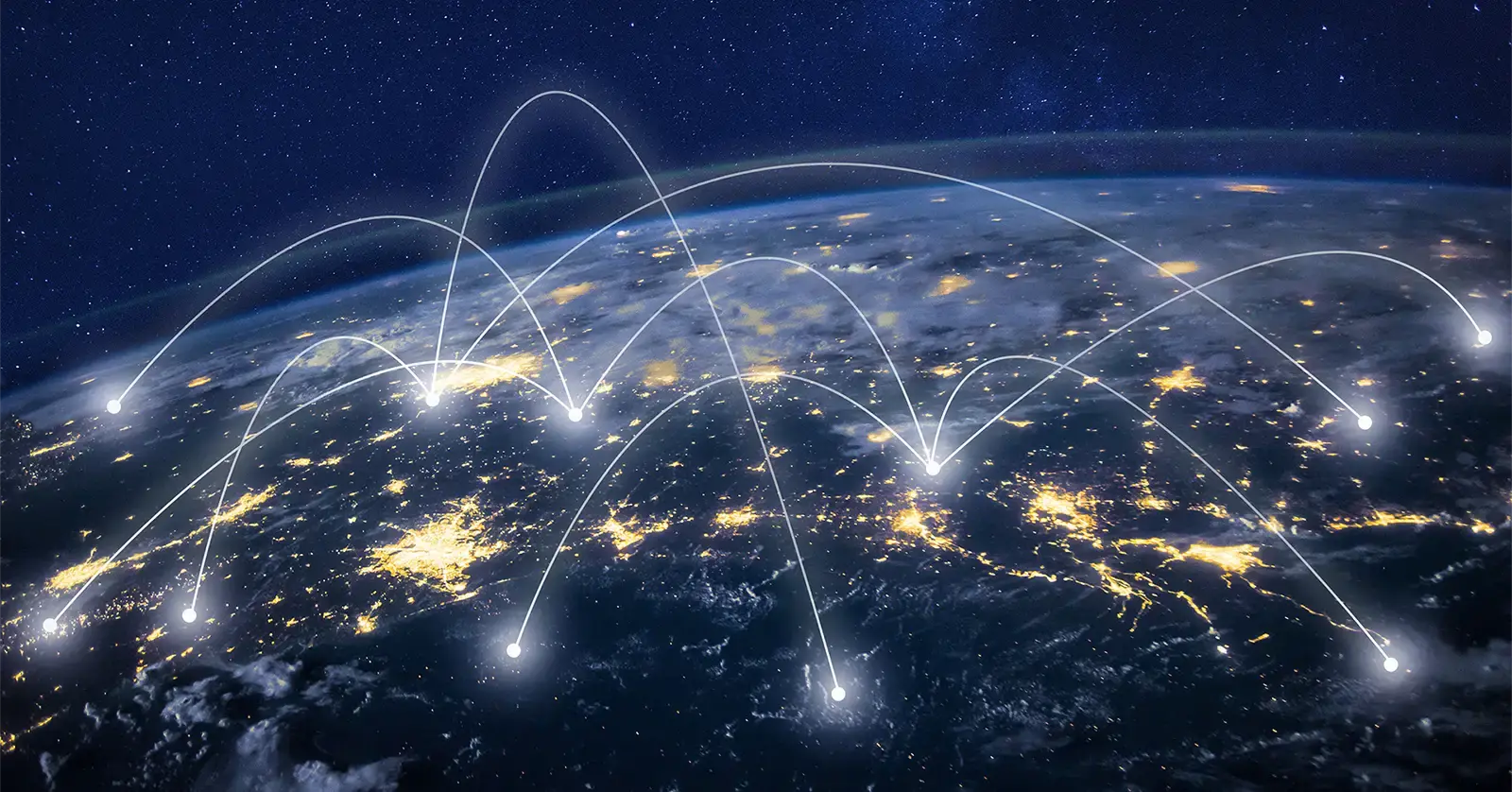 Aerial view of the earth with network lines connecting lit up populated areas