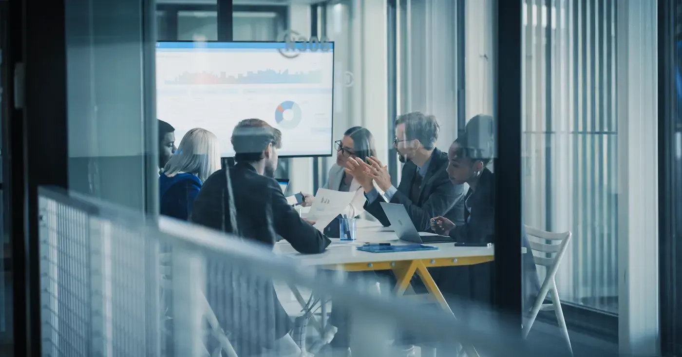 Corporate security team reviewing threat intelligence during an executive protection planning meeting.