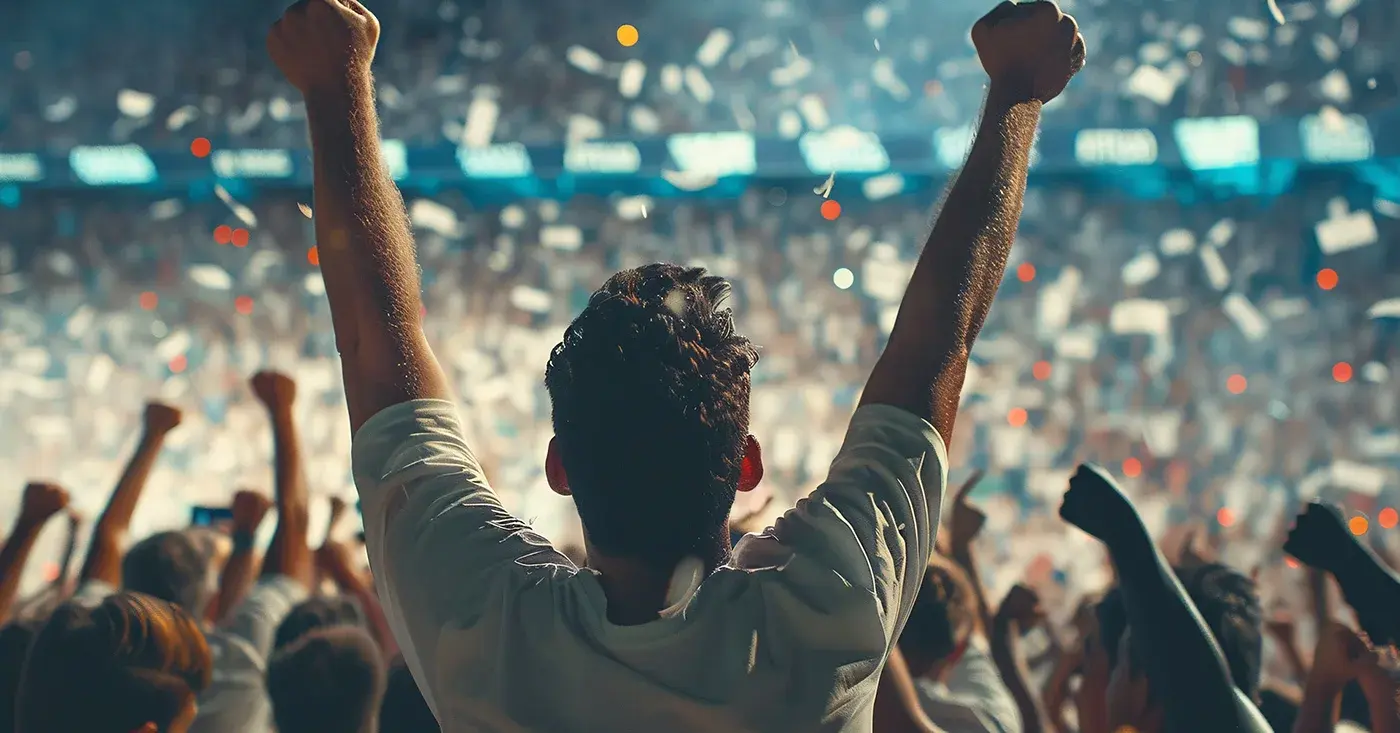 Crowd cheering at a major sporting event, highlighting the importance of threat monitoring and event security planning.